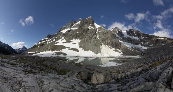 Rugged peak above an alpine tarn