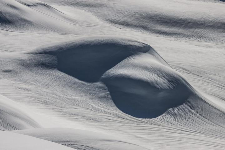 Wind-carved hollow in deep snow