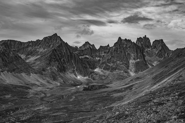 Black-and-white photo of jagged peaks above a valley