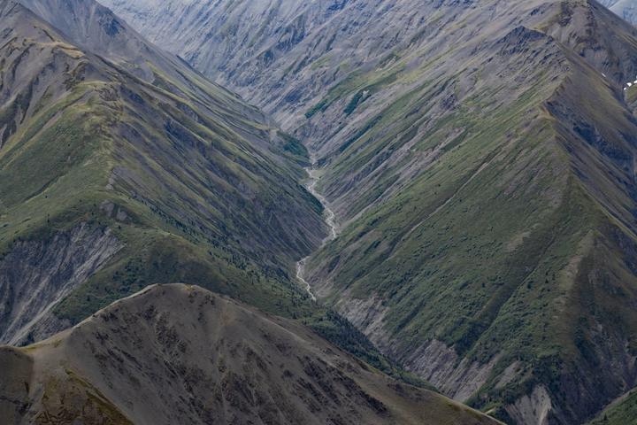 Aerial view of green ridges and a winding valley