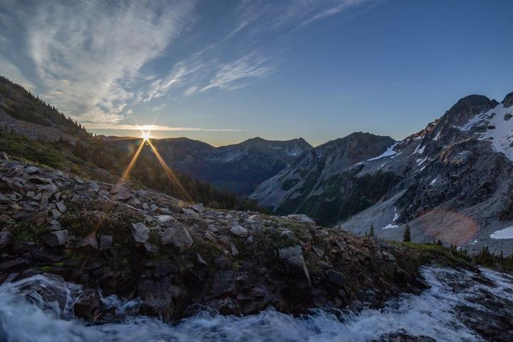Sunburst over a snowy alpine valley